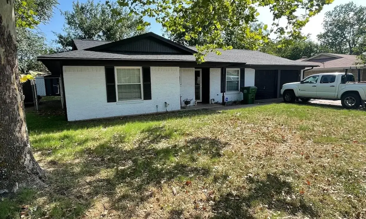Professional roofing crew working on a residential roof in Hernando